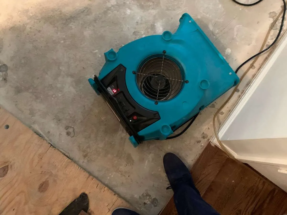 Air mover drying subfloor during Leak Detection & Repair in Yorkville